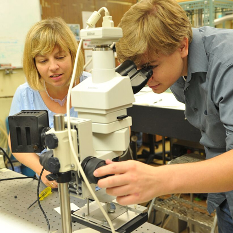 TU faculty member helps a high school student with a STEM workshop project