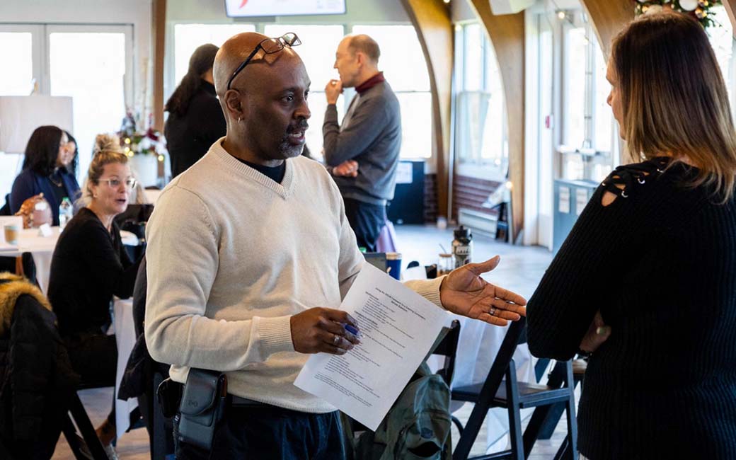 Man and woman speaking at a workshop
