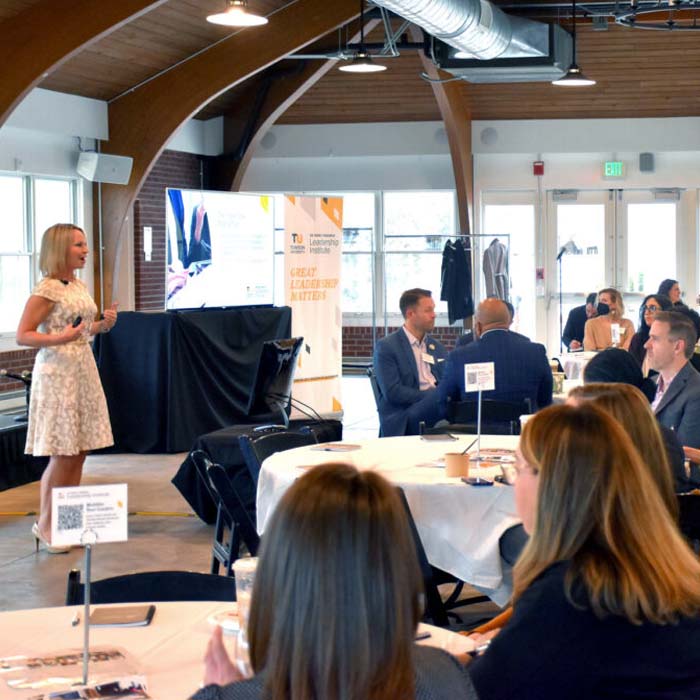 erin moran speaking to audience at a grasmick leadership institute event