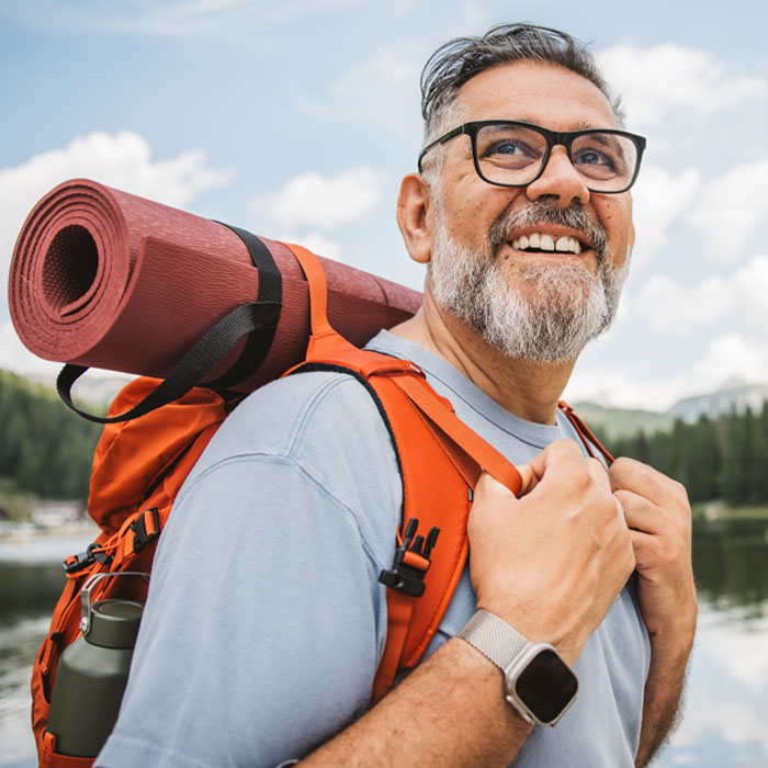 middle aged man with backpack hiking
