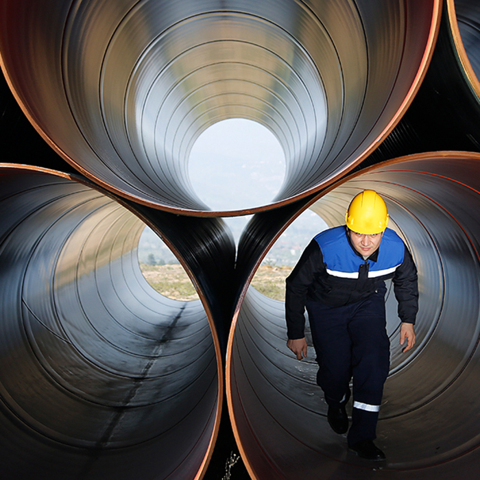 Man walking through industrial tube