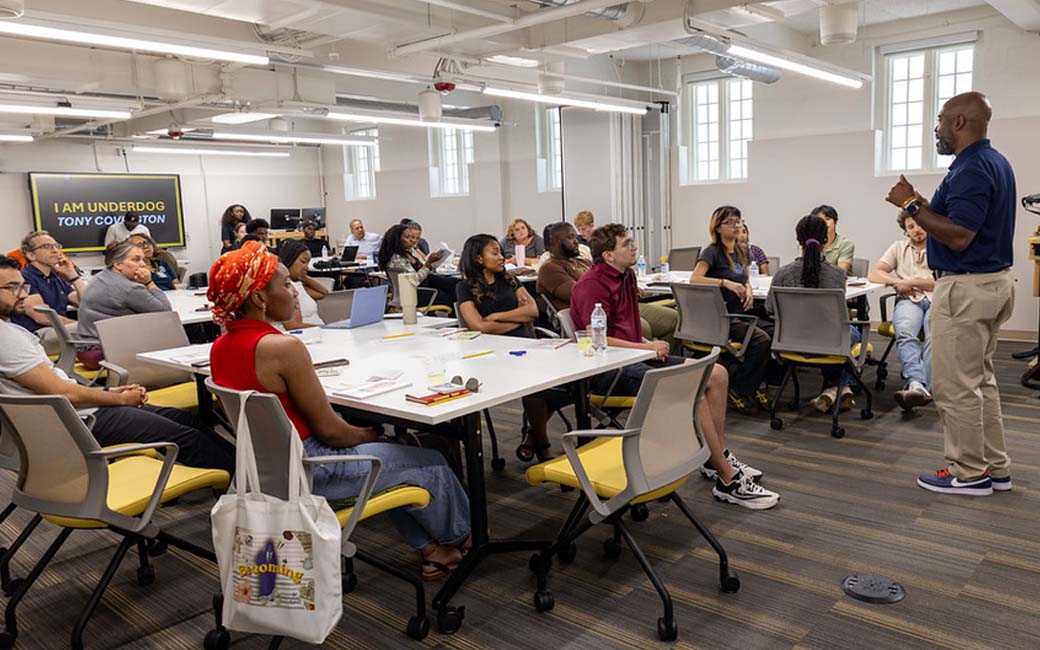 The StarTUp team addressing a room of students