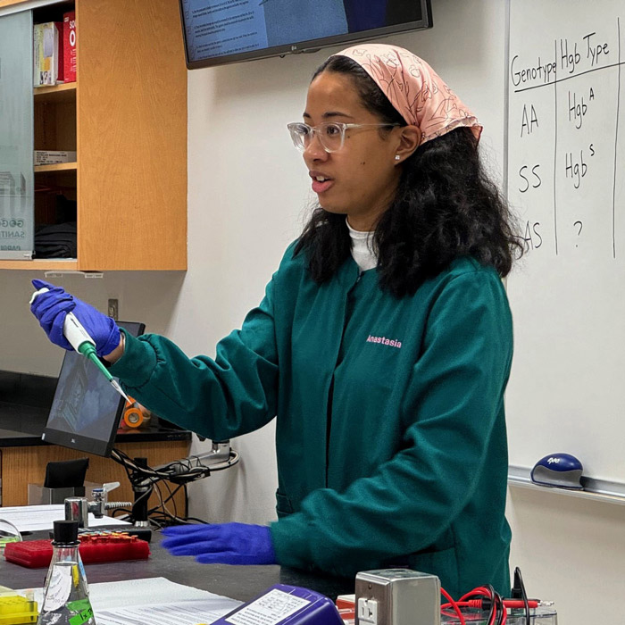 teacher in class with micropipette