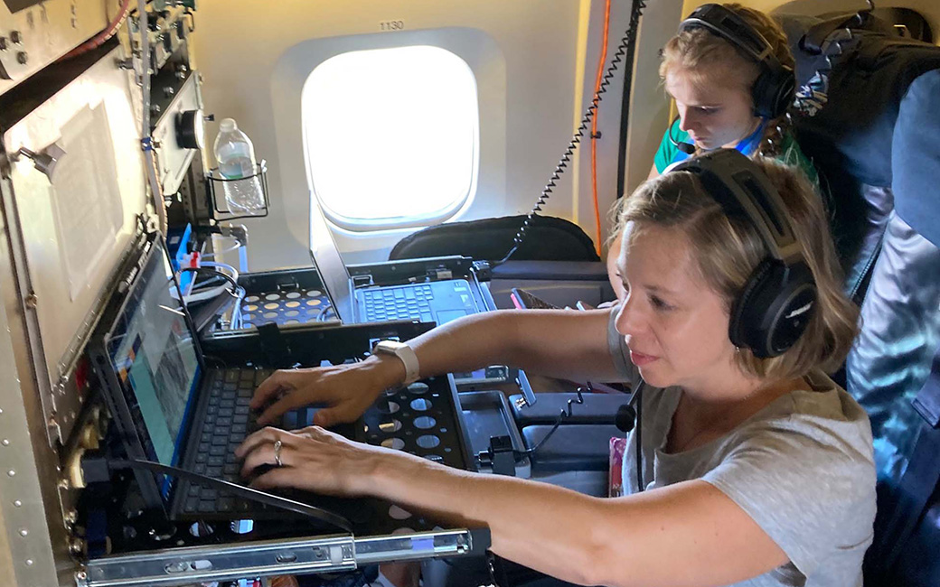 beth kautzman at computer in plane