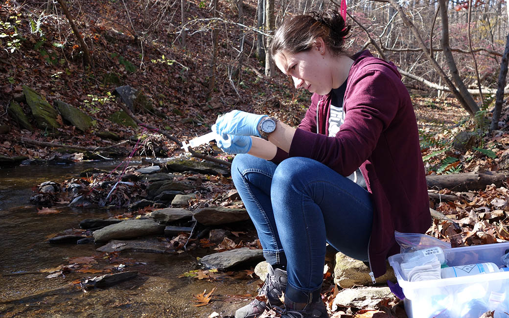 Corey Mueller filtering water samples