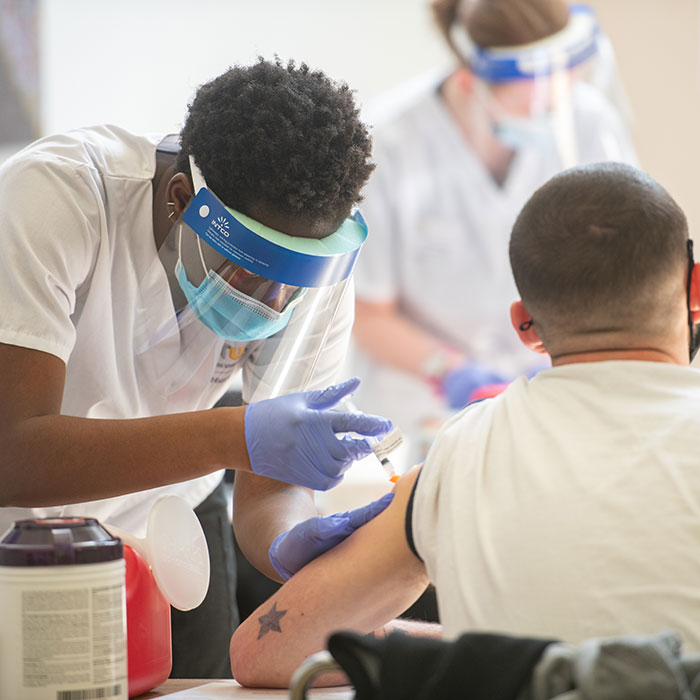 nursing student administering vaccine
