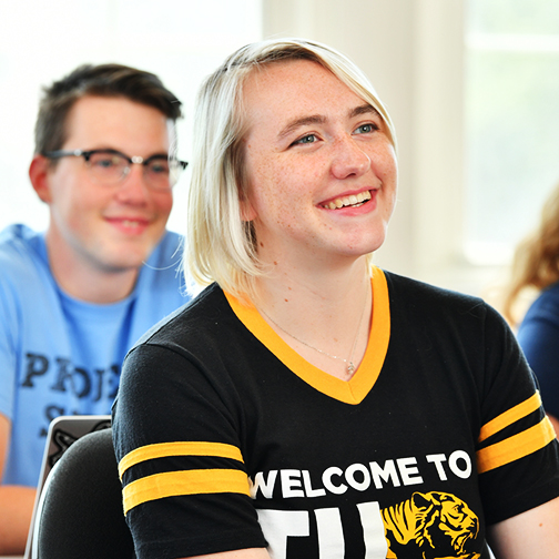 Student smiling in classroom