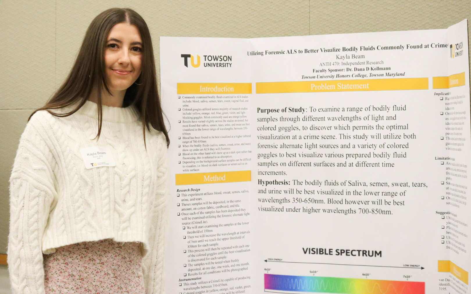 Student standing beside research poster at CSL