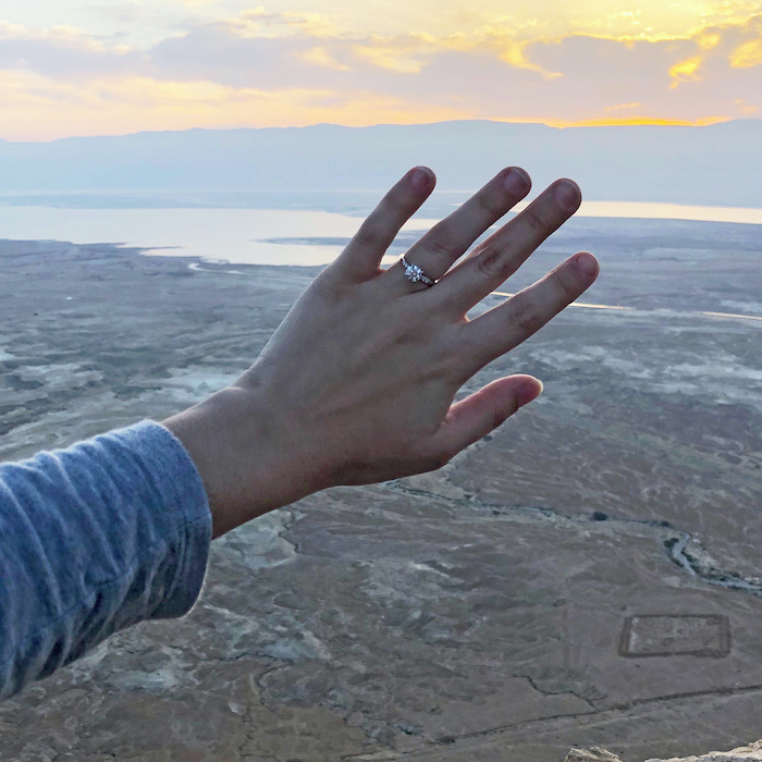 Ashley McArthur holding out hand with engagment ring