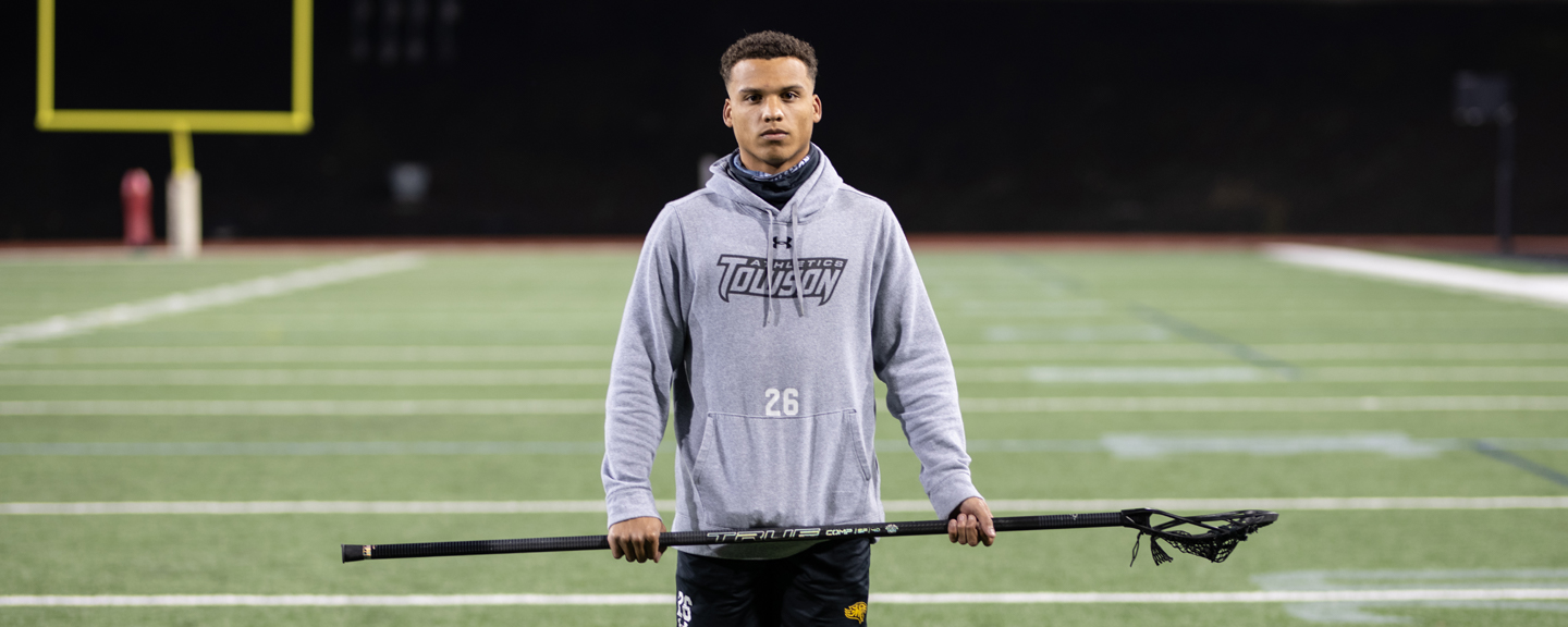 Koby Smith standing alone on a football field