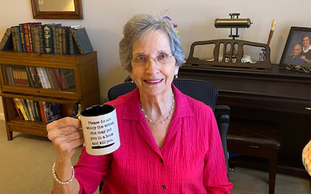 Peggy Rowe drinking a cup of coffee