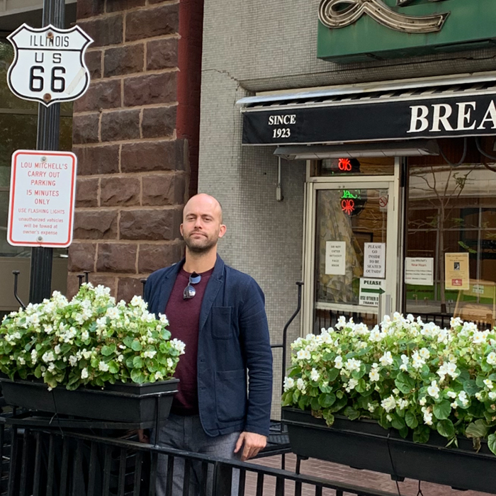 Matt Ayers next to the Route 66 sign in Chicago