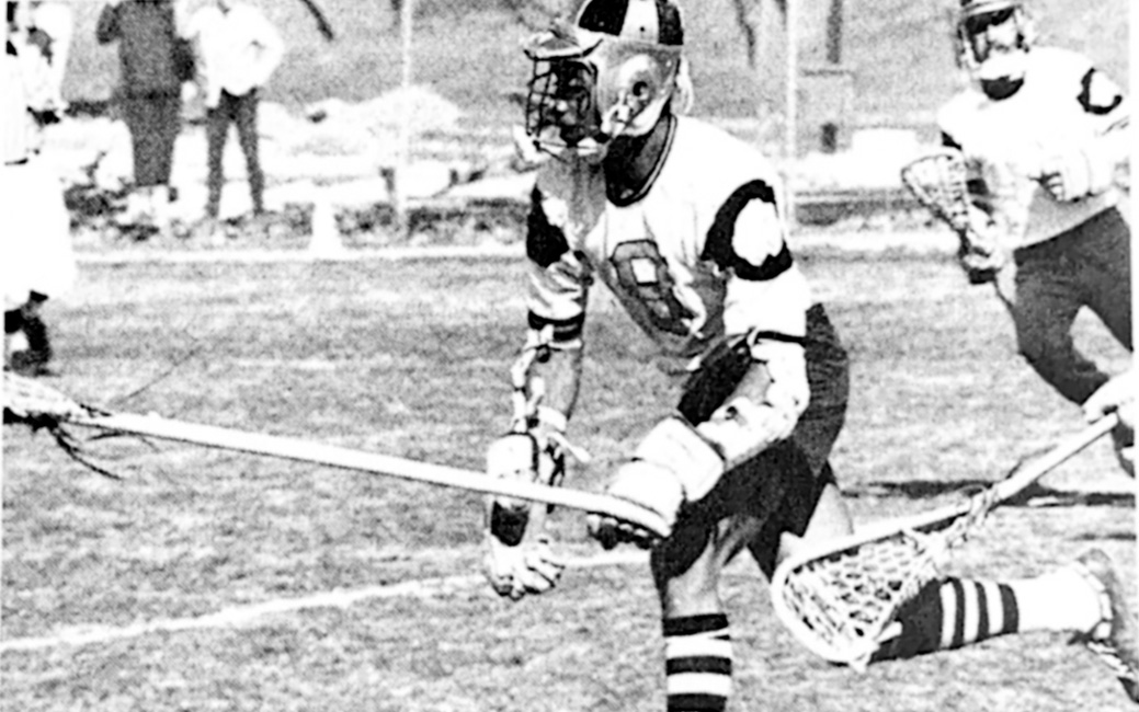black and white photo of a 1970s-era TU men's lacrosse player running