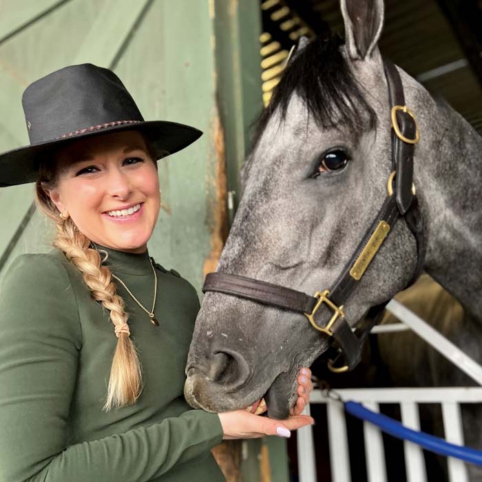 Maggie Wolfendale with a gray and white horse