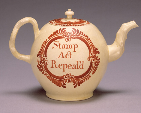 A piece of colonial American pottery that reads: stamp act repealed