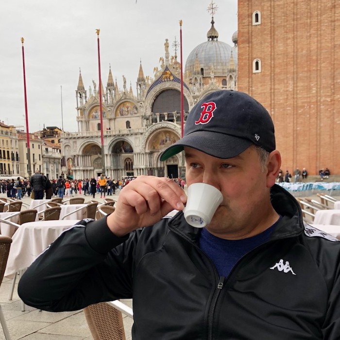 Patrick McQuown drinking coffee in Italy