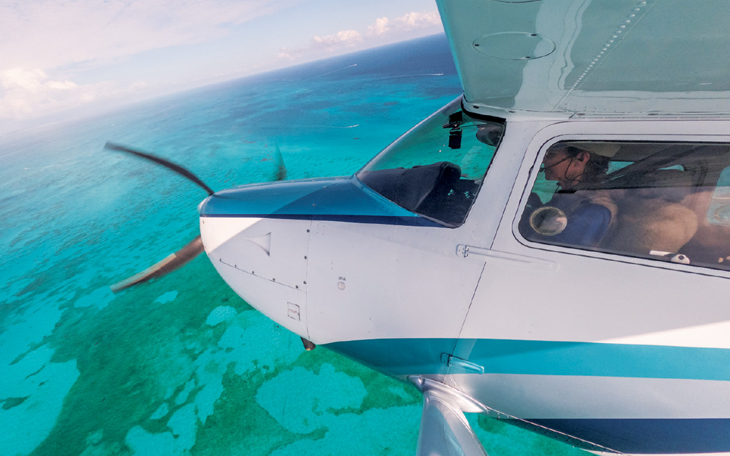 Terry Carbonell flying her plane over water