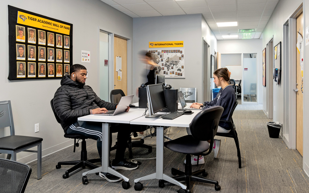 three student-athletes around a conference table