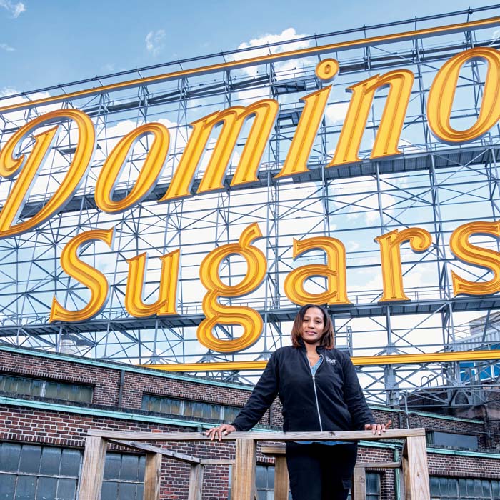 T'Shurah Dove standing in front of the Domino's Sugar sign