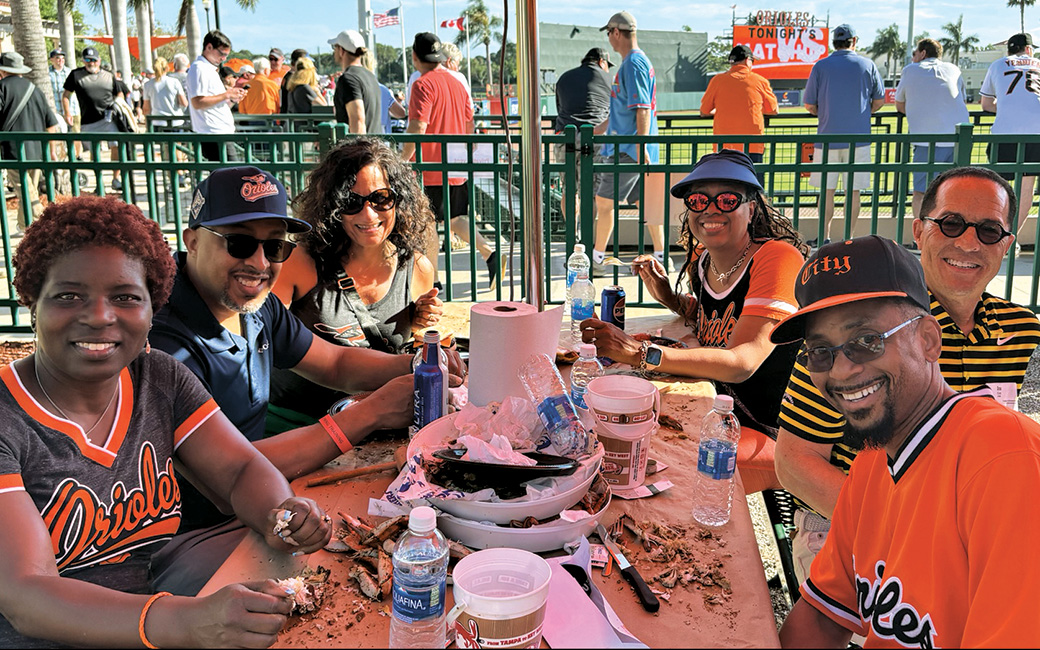 TU alumni eat steamed crabs at an Orioles game