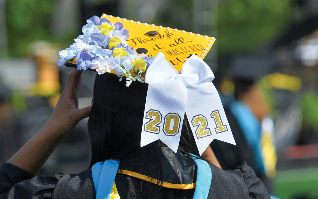 Photo of a graduate wearing a decorated mortarboard