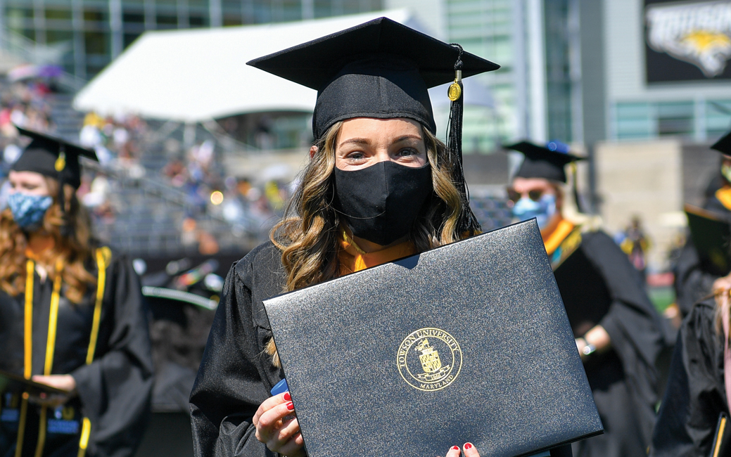 Graduate holding a diploma case