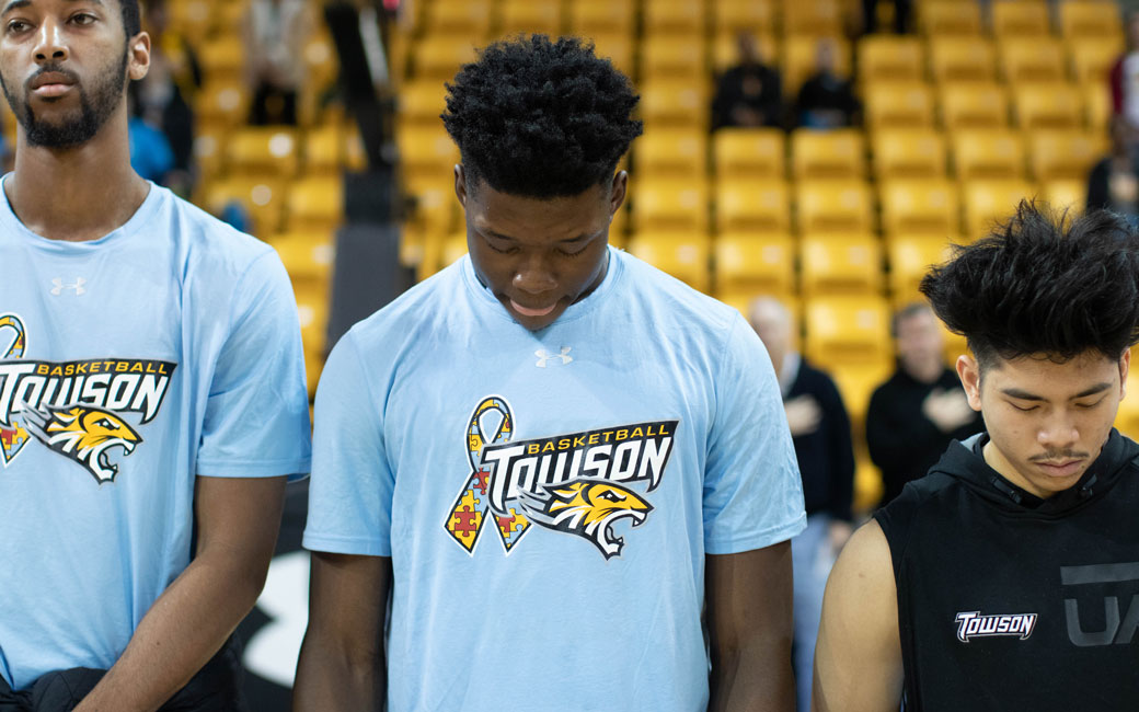 Towson Basketball player wearing autism awareness shirt