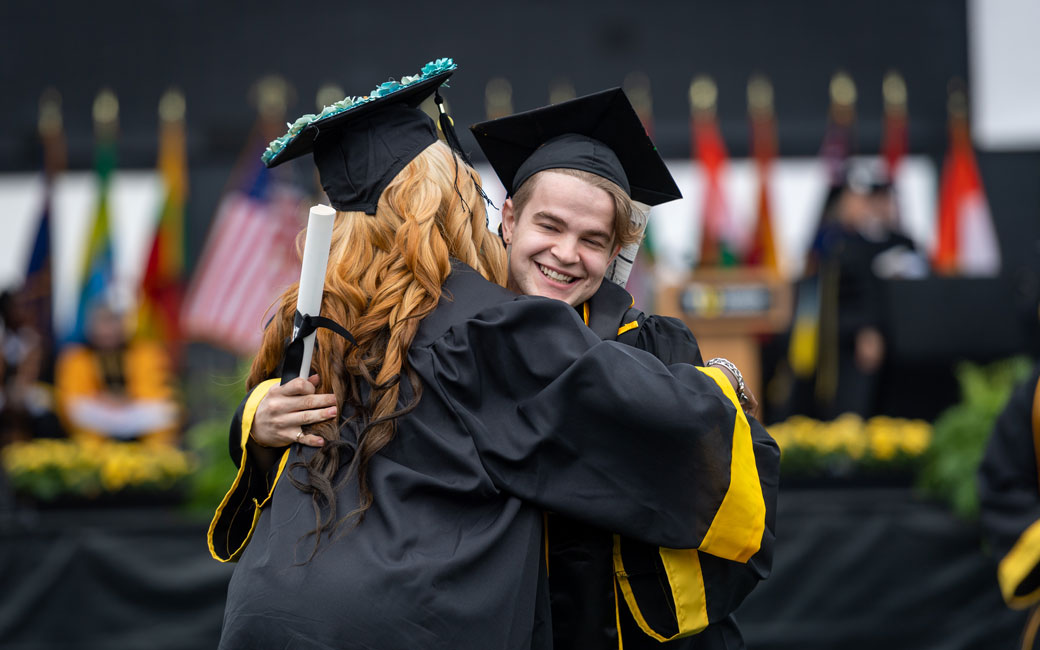 Students hugging during commencement