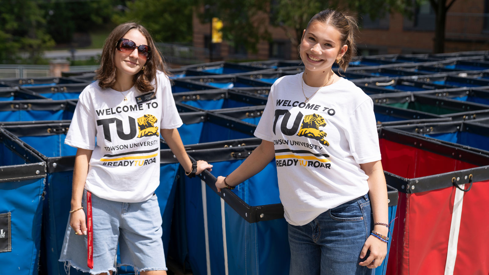 Students stand together near carts used for move-in