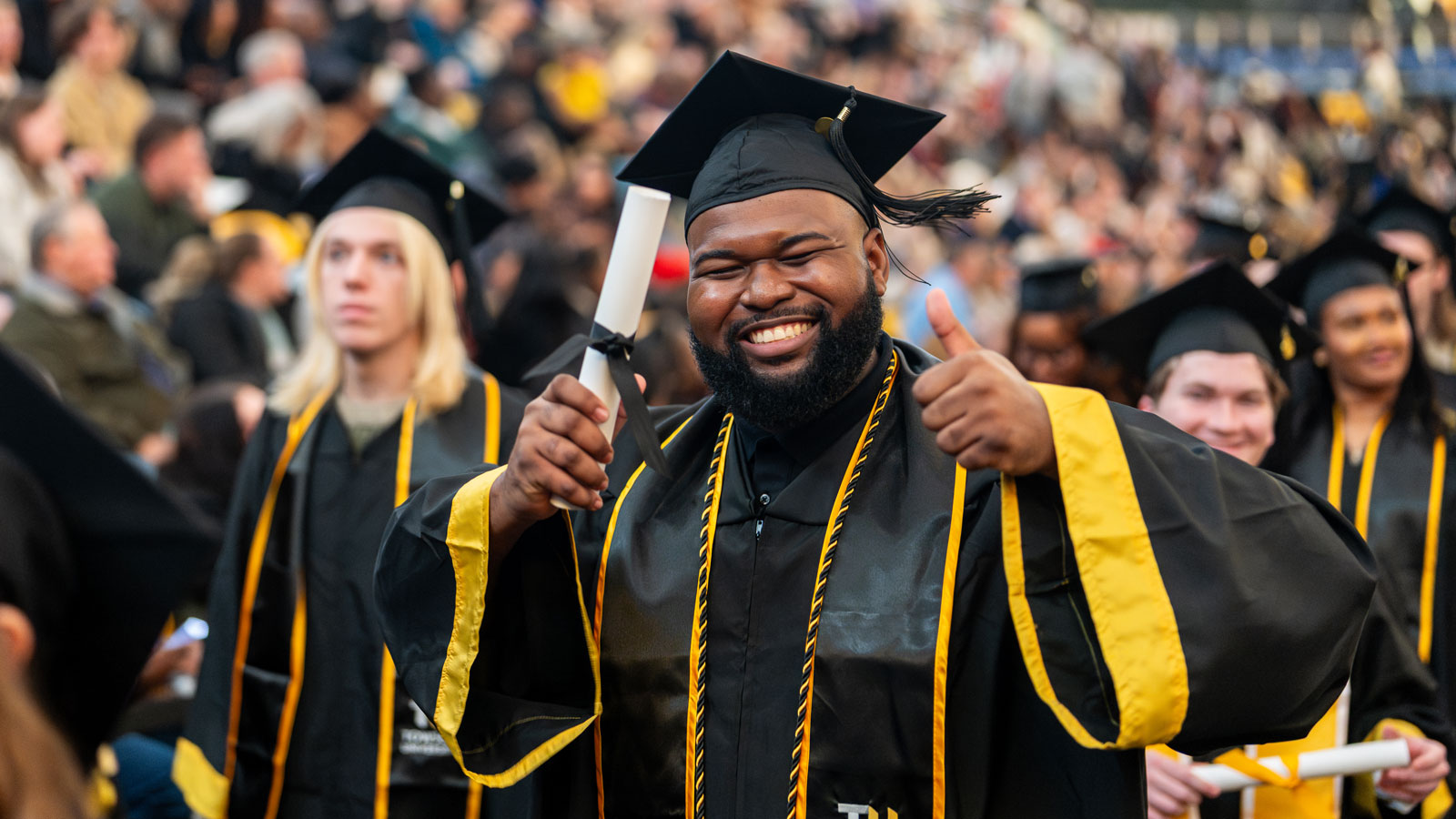A student celebrating at the 2025 Winter Commencement