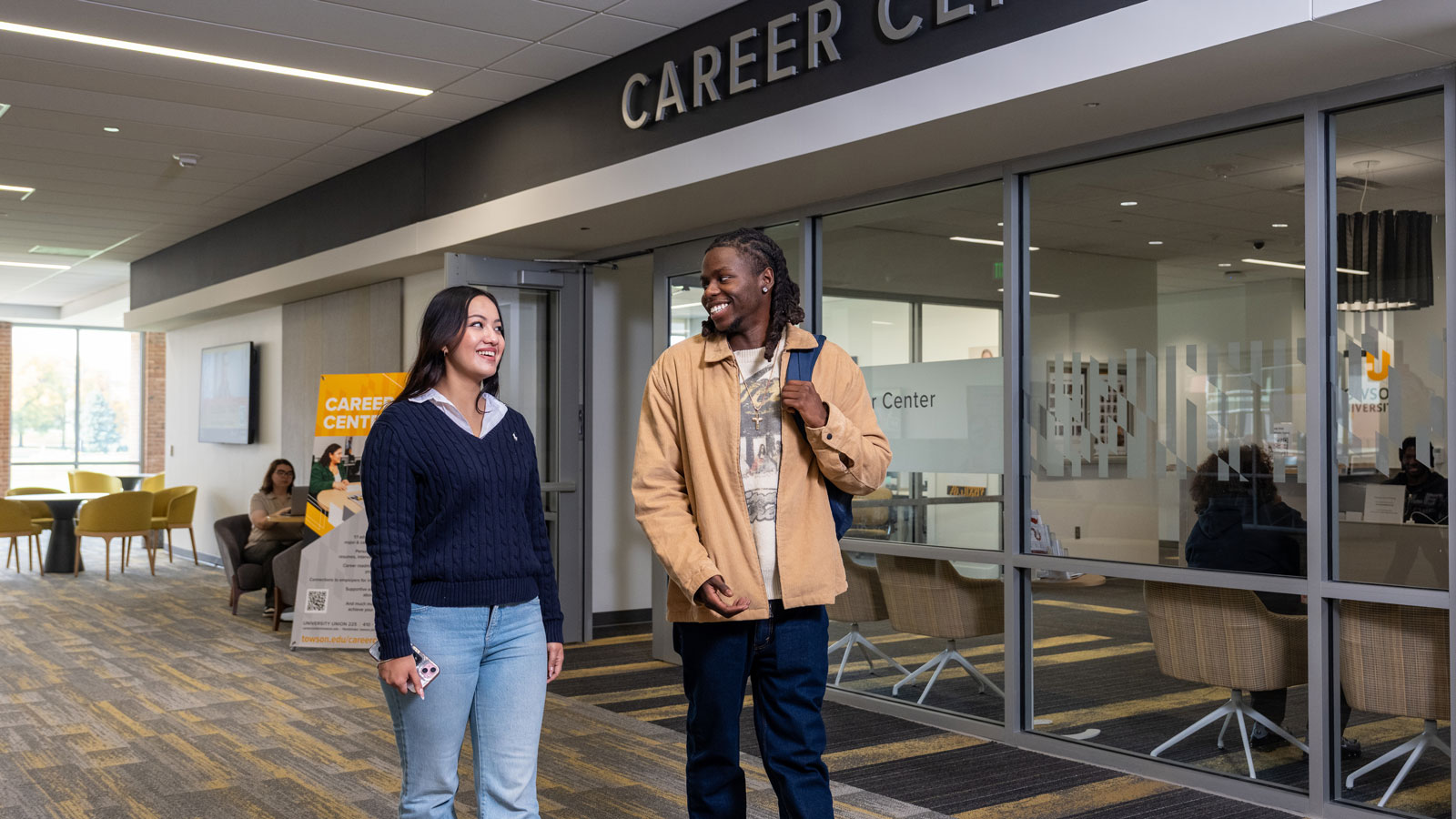 Two students walk by the Towson University Career Center