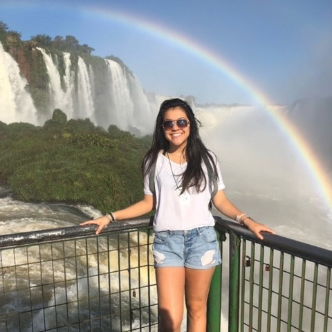 woman posing with rainbow