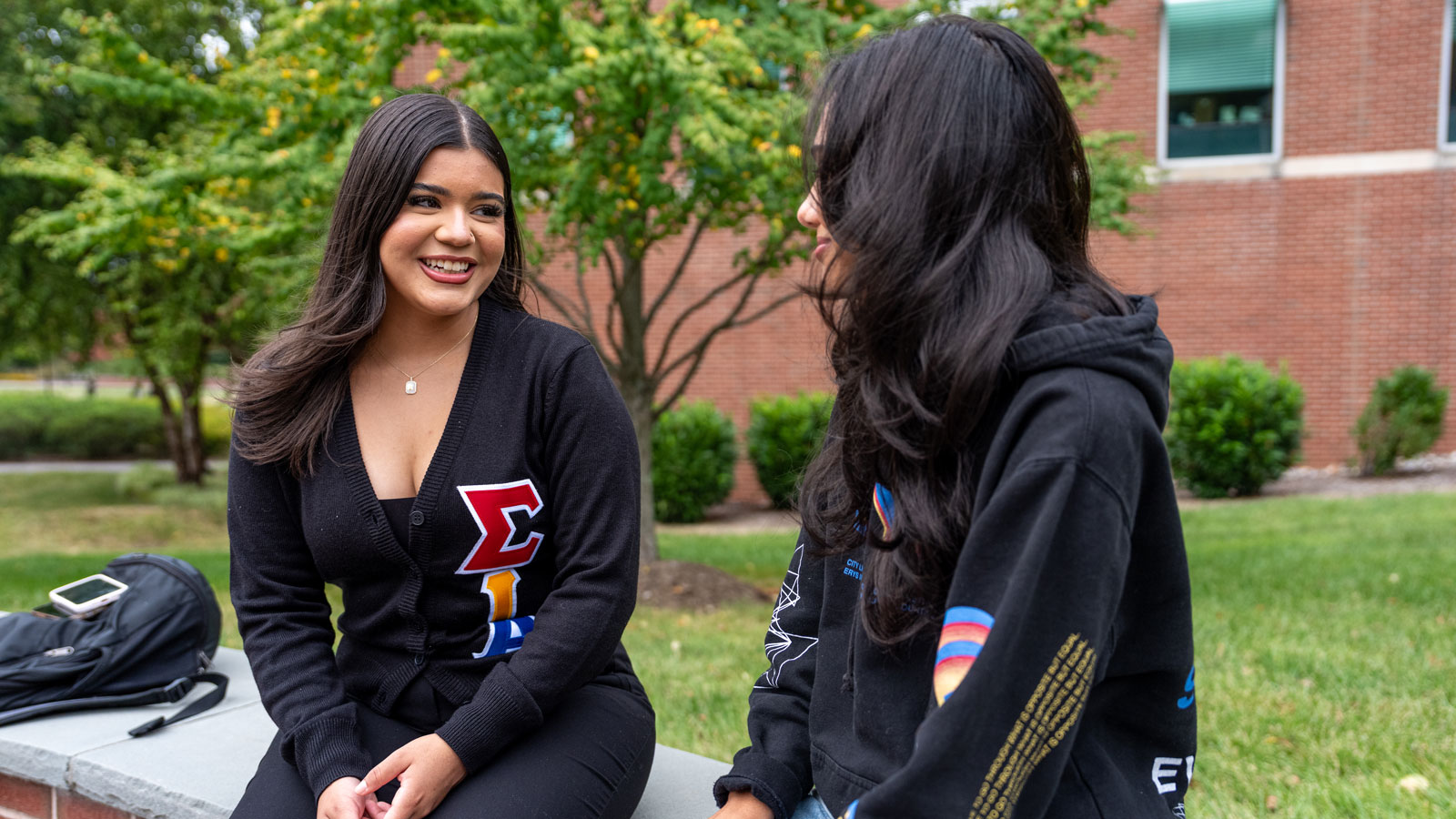 Alexandra Blandon talking with a member of her sorority