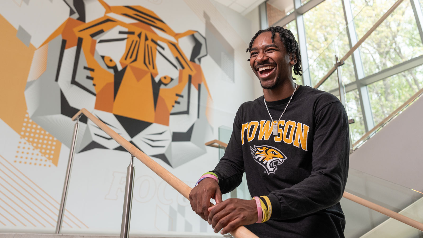 Alphonso Faltz stands under the tiger mural in the Union