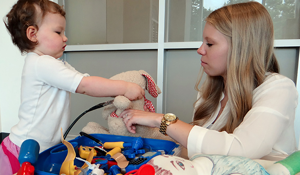 Towson University Child Life graduate students guide young children through stations to help keep their stuffed animals healthy.