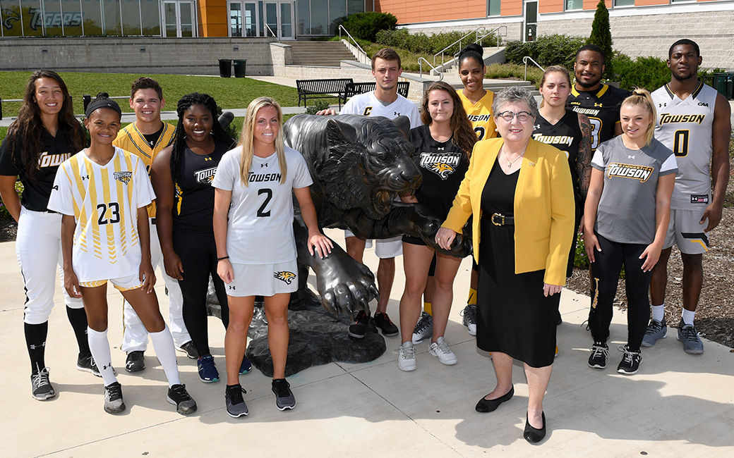 Towson Unviersity Student-Athletes pose with President Kim Schatzel