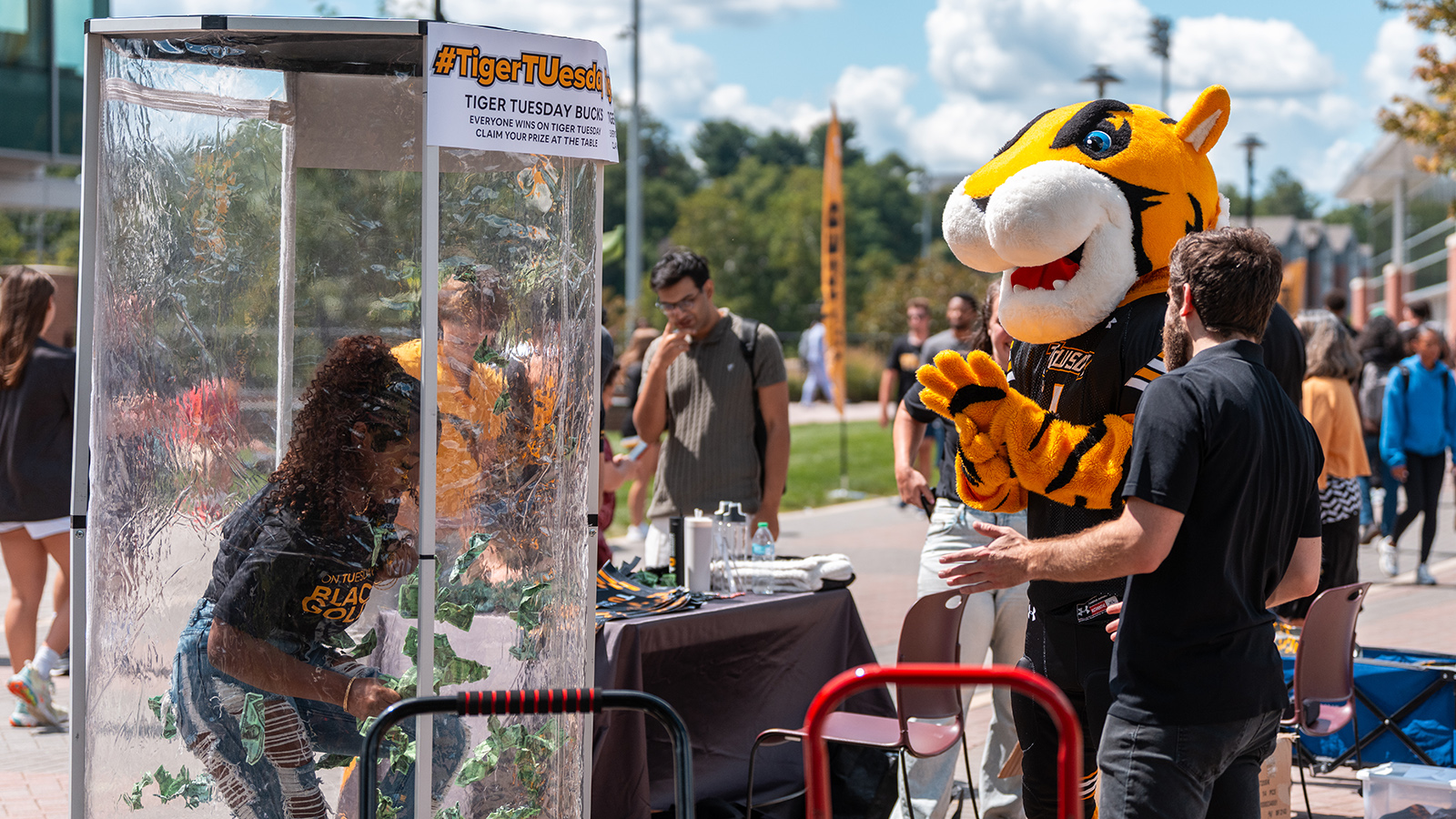 Someone in a money machine with Doc cheering her on