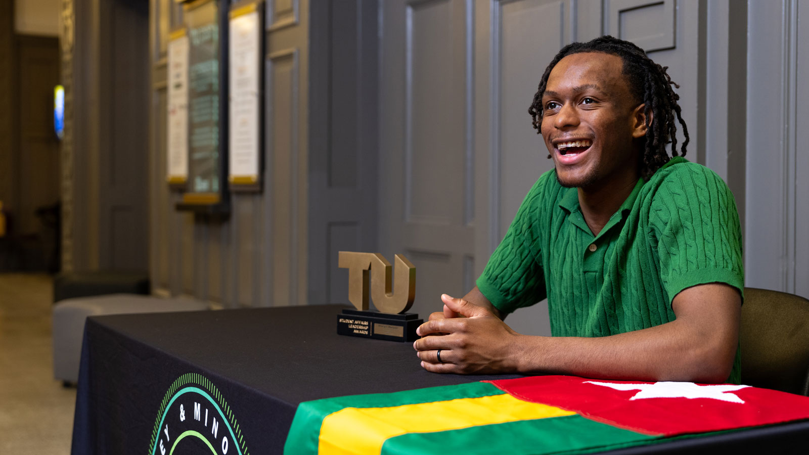 Benedict Adjoyi repping the Money & Minorities student organization and the Togo flag