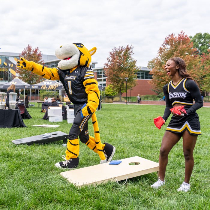 Doc plays cornhole at the inaugural Tiger Tuesday Bash