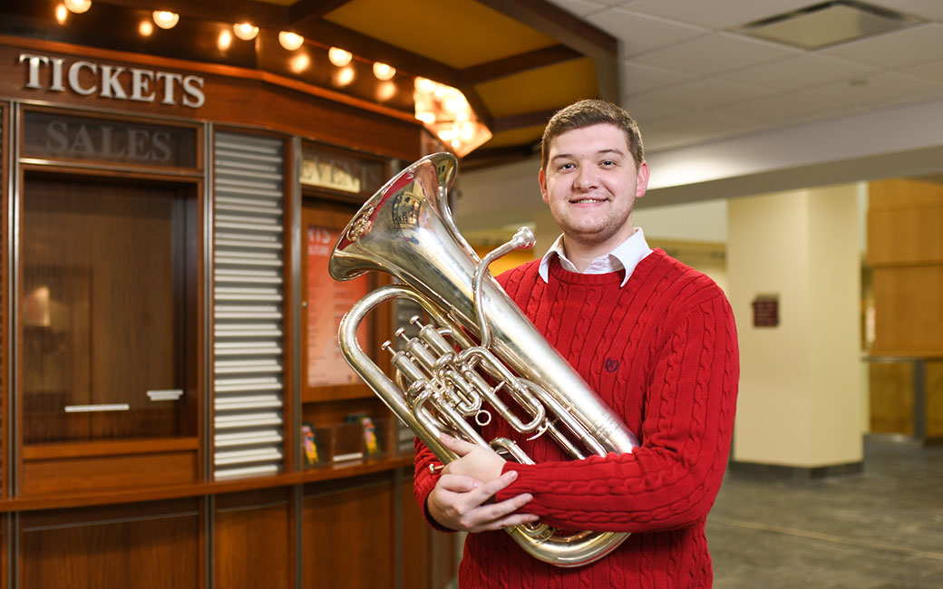 Brennan Traube with euphonium in Center for the Arts