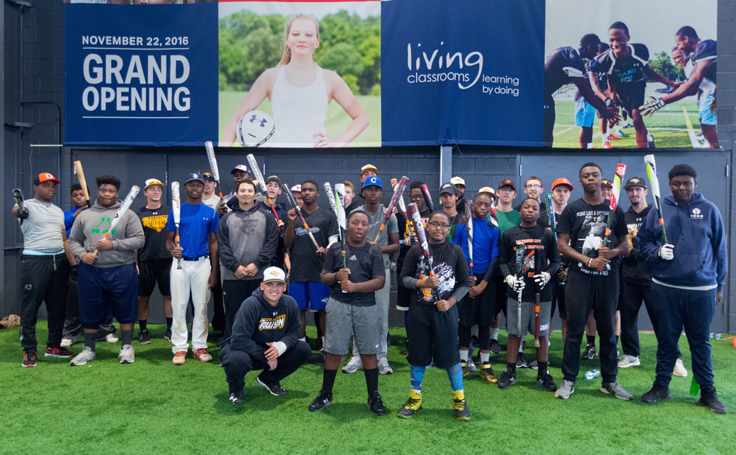 Members of the Towson University baseball team pose with students who participate in the Baltimore Urban Baseball Association (BUBA) camps. TU's student-athletes volunteered at the camps this fall. 