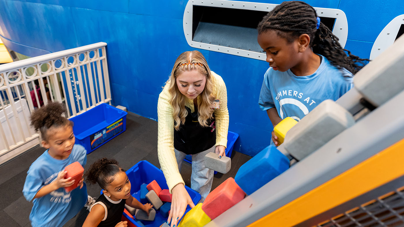 Chelsey McKee playing with young learners