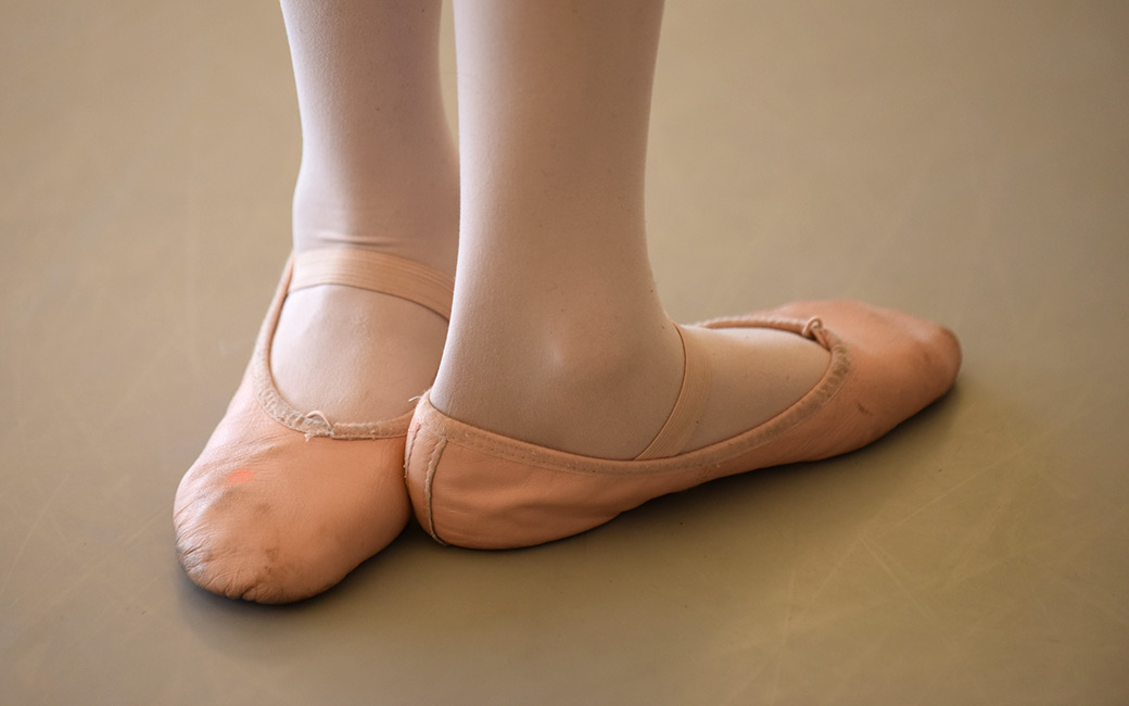 Close-up of feet in tights and ballet shoes