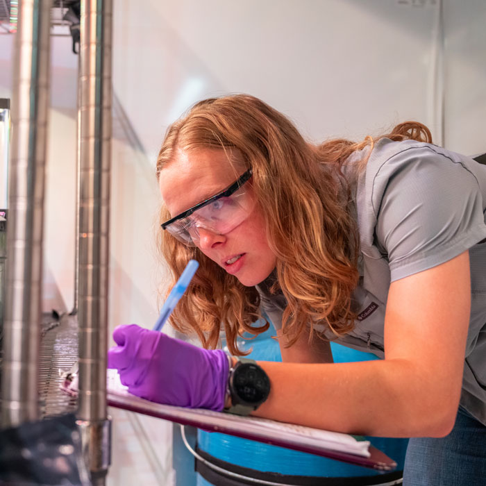 A student doing lab research with the caught crayfish 