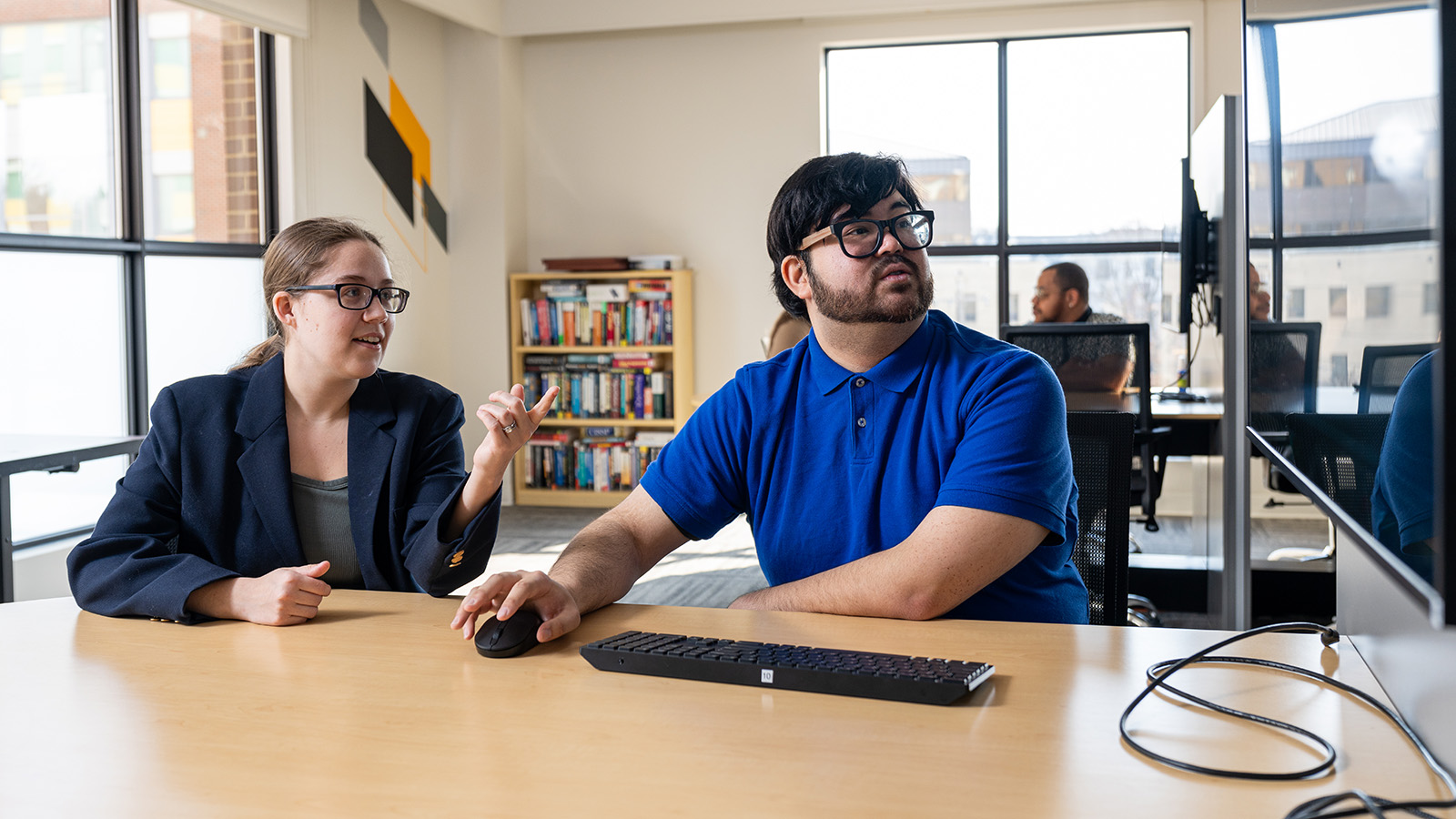Two people looking at a computer screen