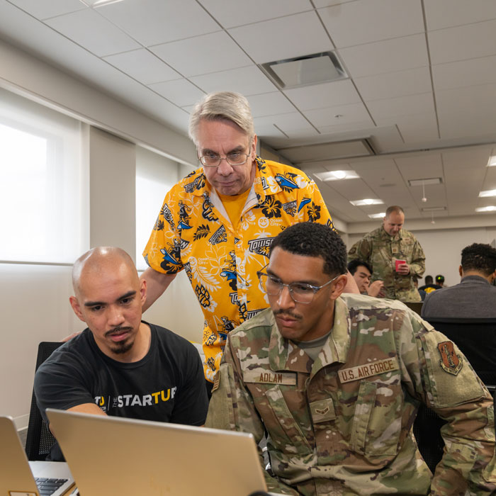Professor O'Leary monitors Cyber Capture the Flag TU student participant and Air Force member