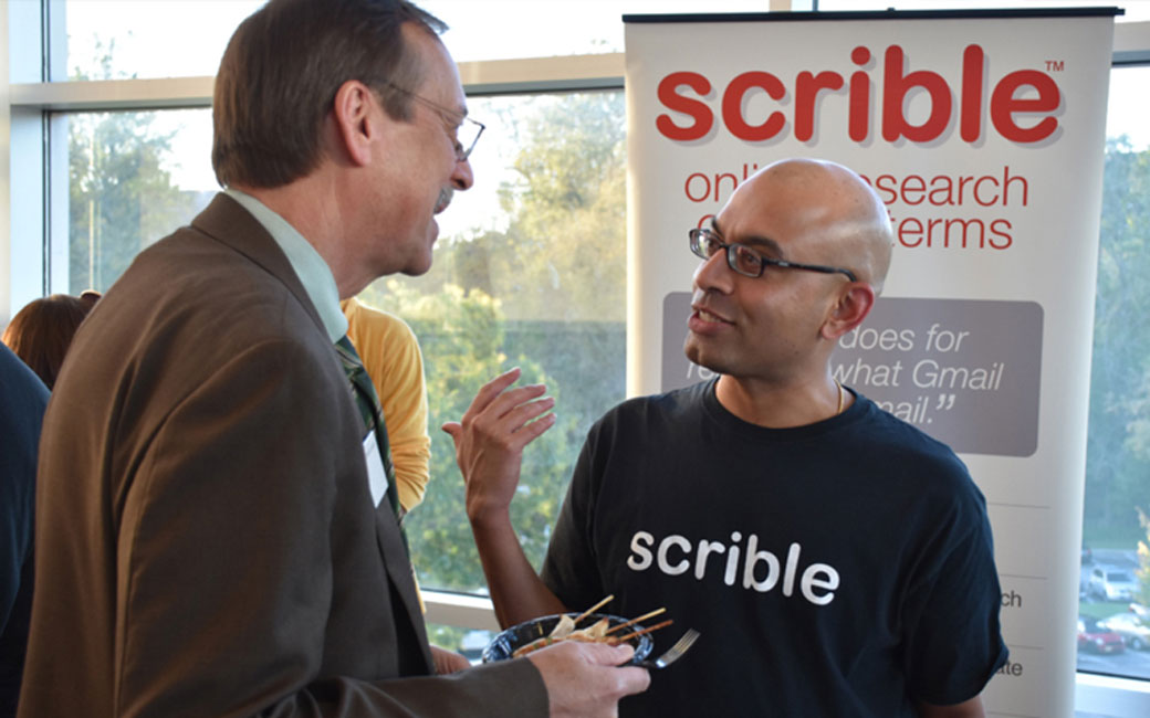 Towson University's Jess & Mildred Fisher College of Science & Mathematics Dean David Vanko speaks with Scrible Co-Founder and CEO Victor Karkar during the TU Incubator's EdTech Innovation Showcase.
