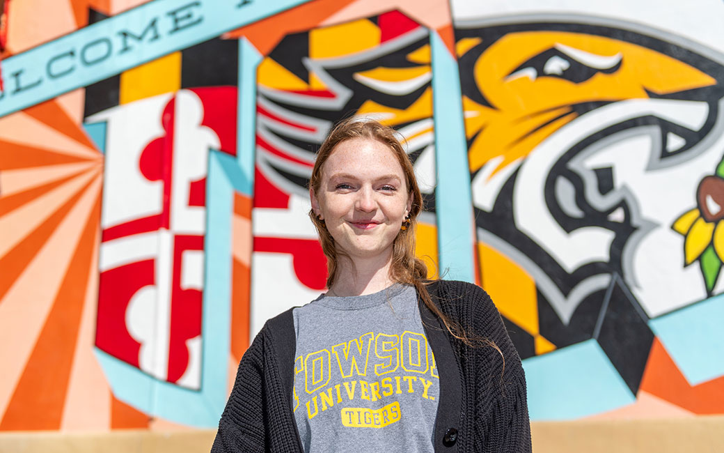 Emily Wannen portrait in front of mural