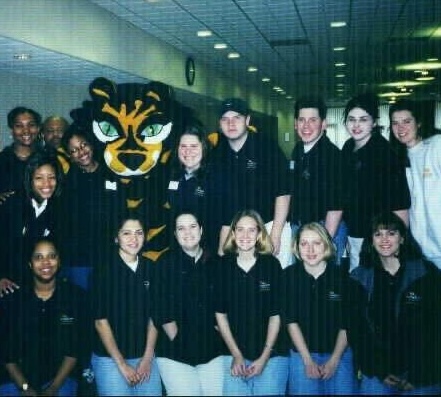 A group of college students posing in black shirts