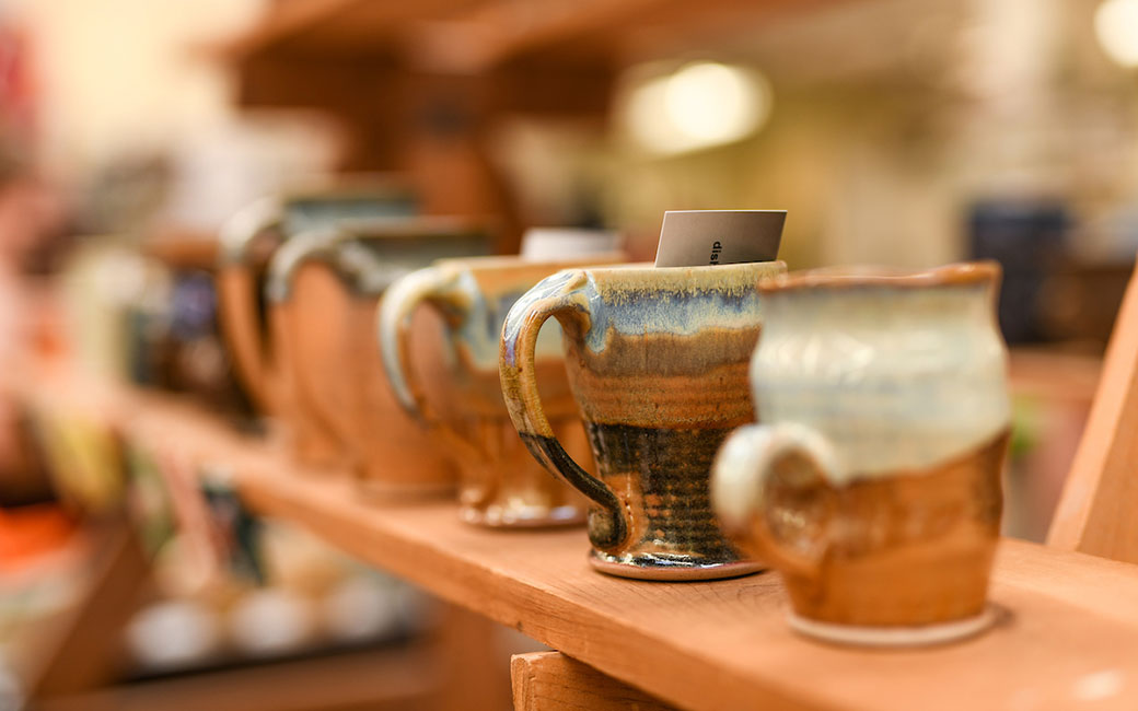 Pottery mugs on shelf